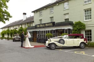 Bride and groom at The Bull Hotel entance